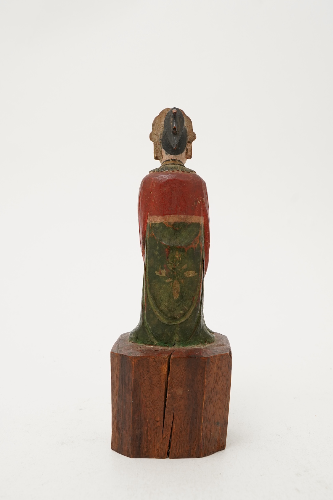 A Chinese polychrome wood figure of a female attendant, Qing dynasty